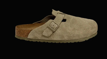 Beige suede clog shoe with a brown sole on a white background
